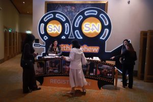 Registration desk with cinema-themed Smith+Nephew Academy conference branding at Sheraton Grand Sukhumvit Bangkok