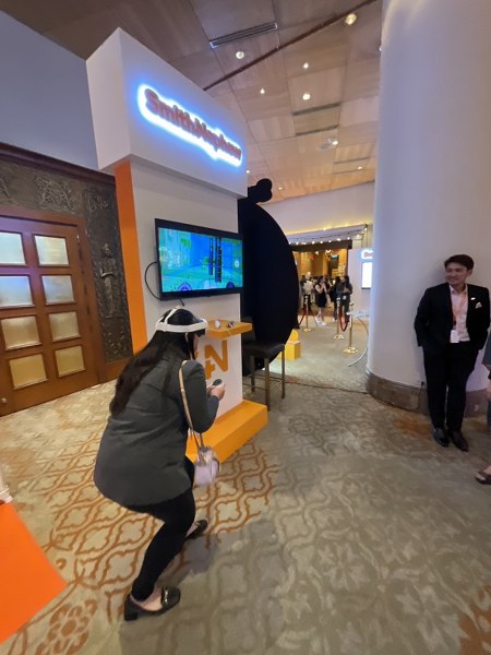 Attendee trying VR headset at the Smith+Nephew Academy conference interactive technology booth
